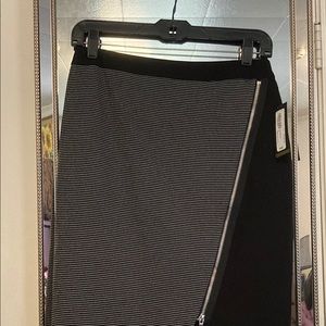 Black skirt with diagonal zipper embellishment.